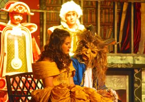 Two students performing in costume in Beauty and the Beast. 