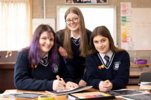 Three students with books. 