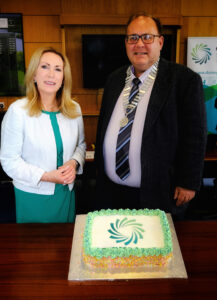 Two people, Chief Executive and Chairperson, with a cake.