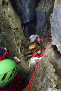 People climbing rocks with ropes.