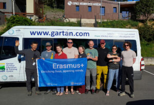 Group of people holding an Erasmus+ flag. 