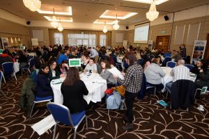 Image of groups of people sitting at tables